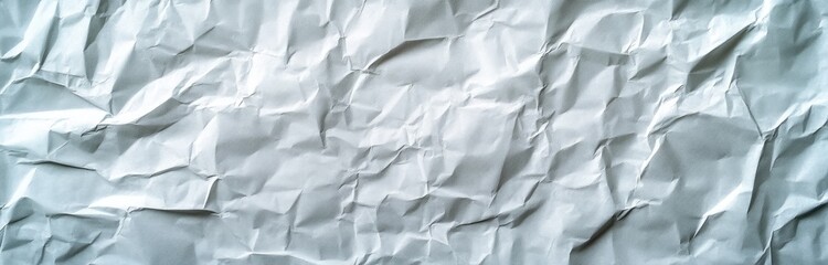 Obraz premium A crumpled sheet of white paper, showcasing texture and depth.