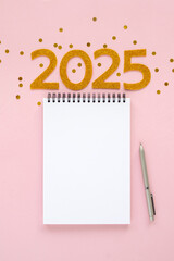 2025 New Year concept with empty notebook for your goals, plans, resolutions. Flat lay style....