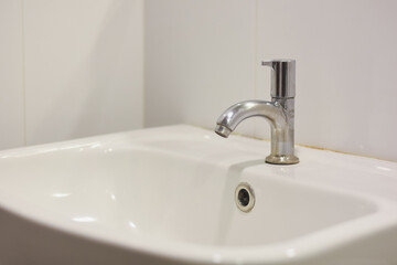 Fototapeta premium Stainless steel faucet in the bathroom