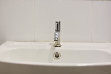 Fototapeta premium Stainless steel faucet in the bathroom