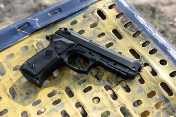 Plastic toy gun on iron surface