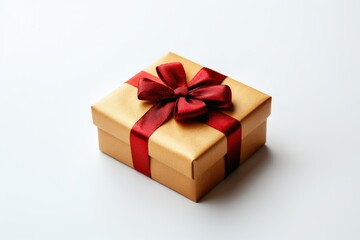 Fototapeta premium Small Gold Gift Box with Red Satin Ribbon and Bow isolated on white background