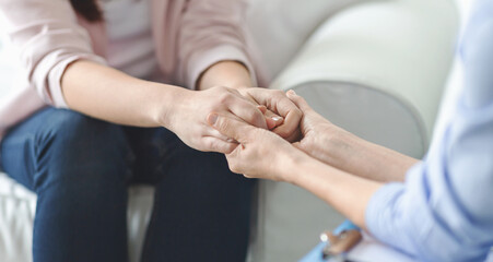 Care, trust, professionalism concept. Close up of therapist holding female patient hands, comforting her client, panorama with copy space