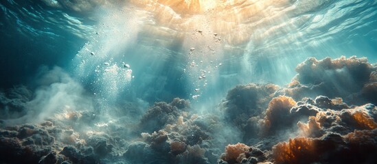 Underwater scene with sunbeams shining through the water, illuminating the ocean floor with coral and bubbles.