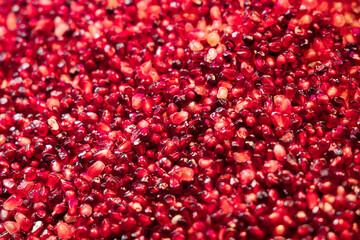 Delicious red ripe juicy pomegranate seed background texture