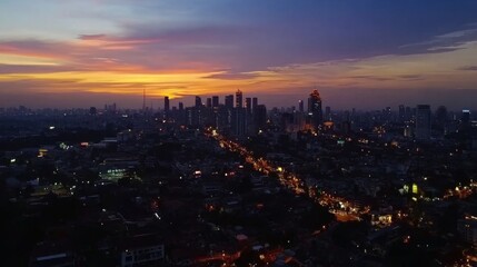 Fototapeta premium Sunset over Urban Cityscape with Vibrant Skies