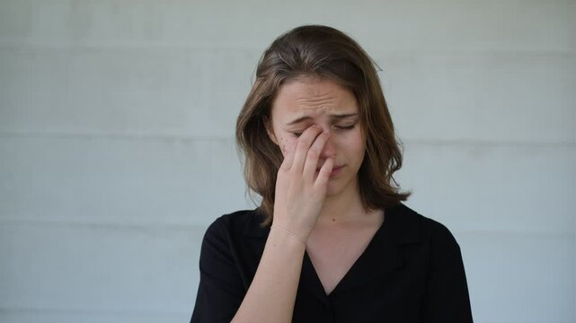 portrait of a young beautiful upset woman barely holding back tears