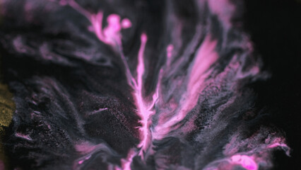 Marble art. Wet acrylic drip. Defocused black neon pink color oil paint spill ink stream wave on dark gold metallic abstract background.