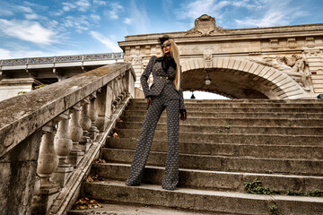 High fashion model. Glamour, stylish elegant woman in black and white suit, fashionable knee boots...
