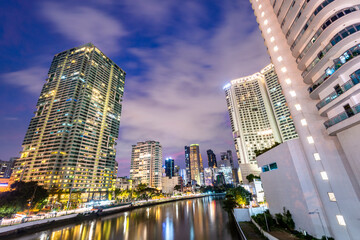 Fototapeta premium Modern city buildings along the Pasig River, at night in the Makati District,Manila,The Philippines.