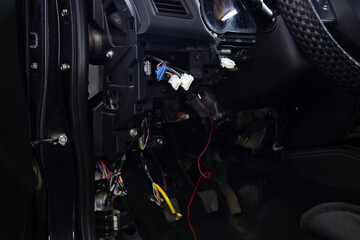 Repair of electrical equipment in the car. An auto electrician repairs a car.