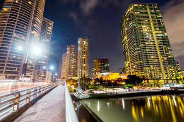 Fototapeta premium Modern city buildings along the Pasig River, at night in the Makati District,Manila,The Philippines.