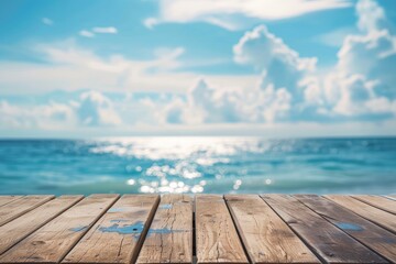 Empty wooden table with blurred tropical beach background for product display concept.