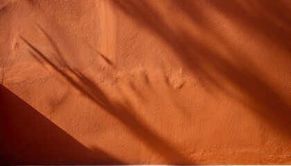 Warm Textured Orange Stucco Wall with Strong Diagonal Sunlight Shadow. Ideal for Rustic and Minimalist Backgrounds, Mood Boards, or Creative Design Concepts Evoking Warmth and Natural Texture