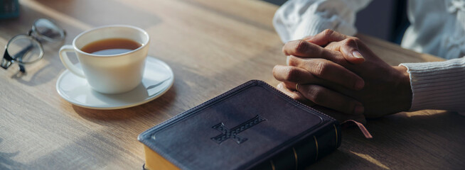 Pray and bible concept. Hand in hand together on bible by woman (worship christian), thinking and...