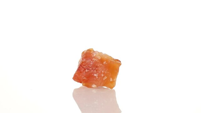 mineral stone carnelian rotates in a circle on a white background