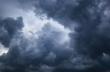 Obraz premium The dark sky with heavy clouds converging and a violent storm before the rain.Bad or moody weather sky and environment. carbon dioxide emissions, greenhouse effect, global warming, climate change.