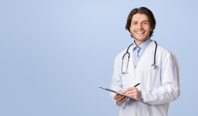 Health Insurance. Portrait Of Young Friendly Doctor With Medical Chart In Hands Posing Over Light Studio Background, Smiling At Camera, Copy Space
