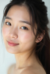Obraz premium A captivating close-up portrait of an Asian woman showcases her radiant beauty and confidence.