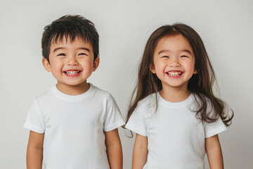 photo of asian toddler boy and girl wearing white t-shirts on grey background