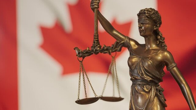 Lady Justice statue with Canadian flag as background. Canada Law and justice concept. Legal system.