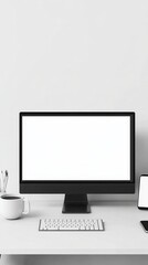 Fototapeta premium A sleek monitor shows a blank white screen, alongside a coffee cup and smartphone on the desk