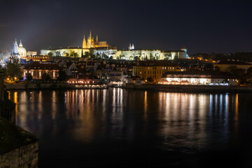 Fototapeta premium Prag city center at night, photographed by Vltava River with the fortress and Charles bridge