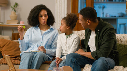 African American mother speech therapist hold letter teach pronounce sound word talk correct...