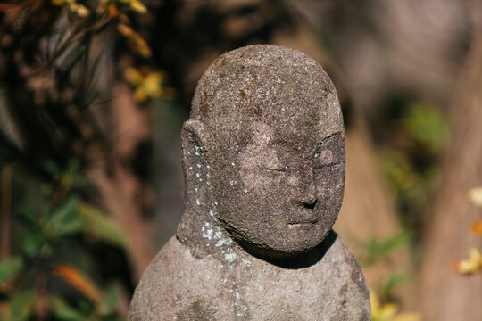A small praying monk statue at Hase Dera Temple in Kamakura.