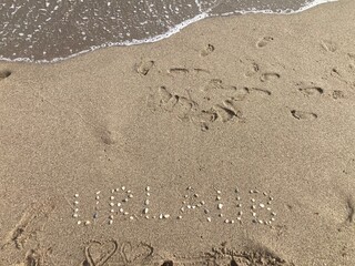 Close-up of a sandy beach with the word 