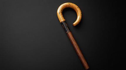 A cane umbrella with a wooden handle, set against a plain background