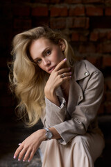 An elegant woman poses in an urban setting, showcasing her fashionable outfit with confidence