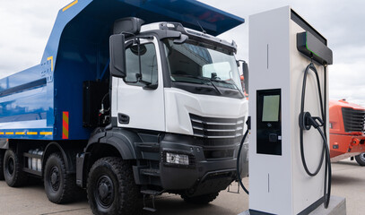 Electric vehicles charging station on a background of a trucks. Concept.