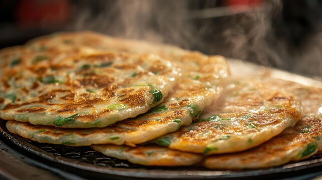 Close-up of fried Chinese scallion pancakes (laobing), served hot from a street food vendor, showcasing its golden, flaky layers.