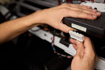 Skilled Hands Connecting Various Electrical Connectors in Automotive Repair Services and Maintenance