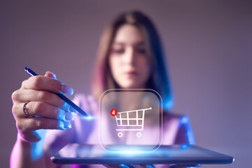 Online shopping. Woman places item in shopping cart on tablet computer. Digital shopping technologies. Blurred girl makes purchases in online store. Woman entrepreneur trading on marketplace