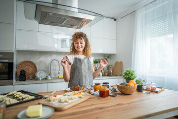 Woman caucasian female prepare breakfast croissants dough at kitchen