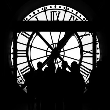 Paris, France: Orsay Museum Clock with silhouette of tourists taking picture