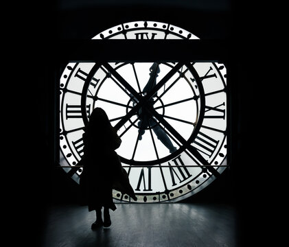 Paris, France: Orsay Museum Clock with silhouette of tourists taking picture