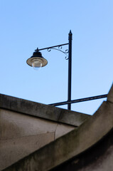 A vintage-style street lamp against a clear blue sky.