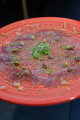 Mediterranean Tuna Carpaccio with Pistachio on Black Background