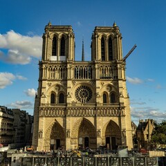 Notre-Dame Cathedral in Paris under blue skies.