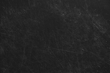 Plastic cutting black board all in cuts from a knife, board in scratches