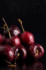Macro of Delicious Fresh Red Wet Cherries with Black Background