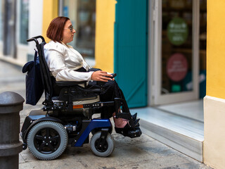 Woman in Wheelchair Facing Inaccessible Store Entrance