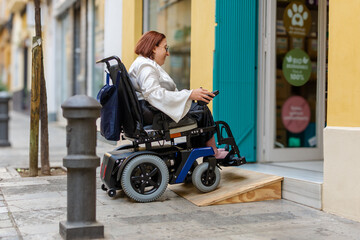 Wheelchair User Safely Using Ramp to Enter Urban Store