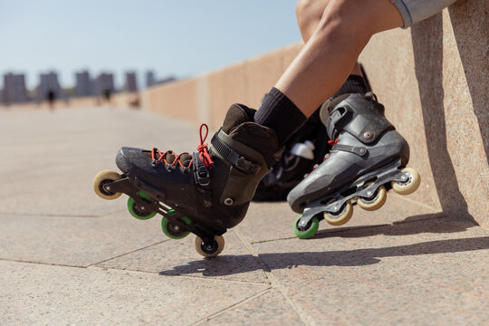 Close-up view of young person rollerblading in city