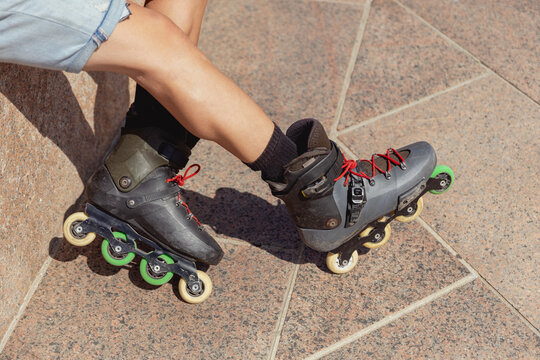Close-up view of young person rollerblading in city