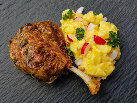 grilled pig wings - sliced open pork knuckle of a young pig