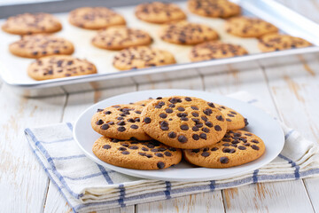 Chocolate chip cookies on white wooden table, selective focus.